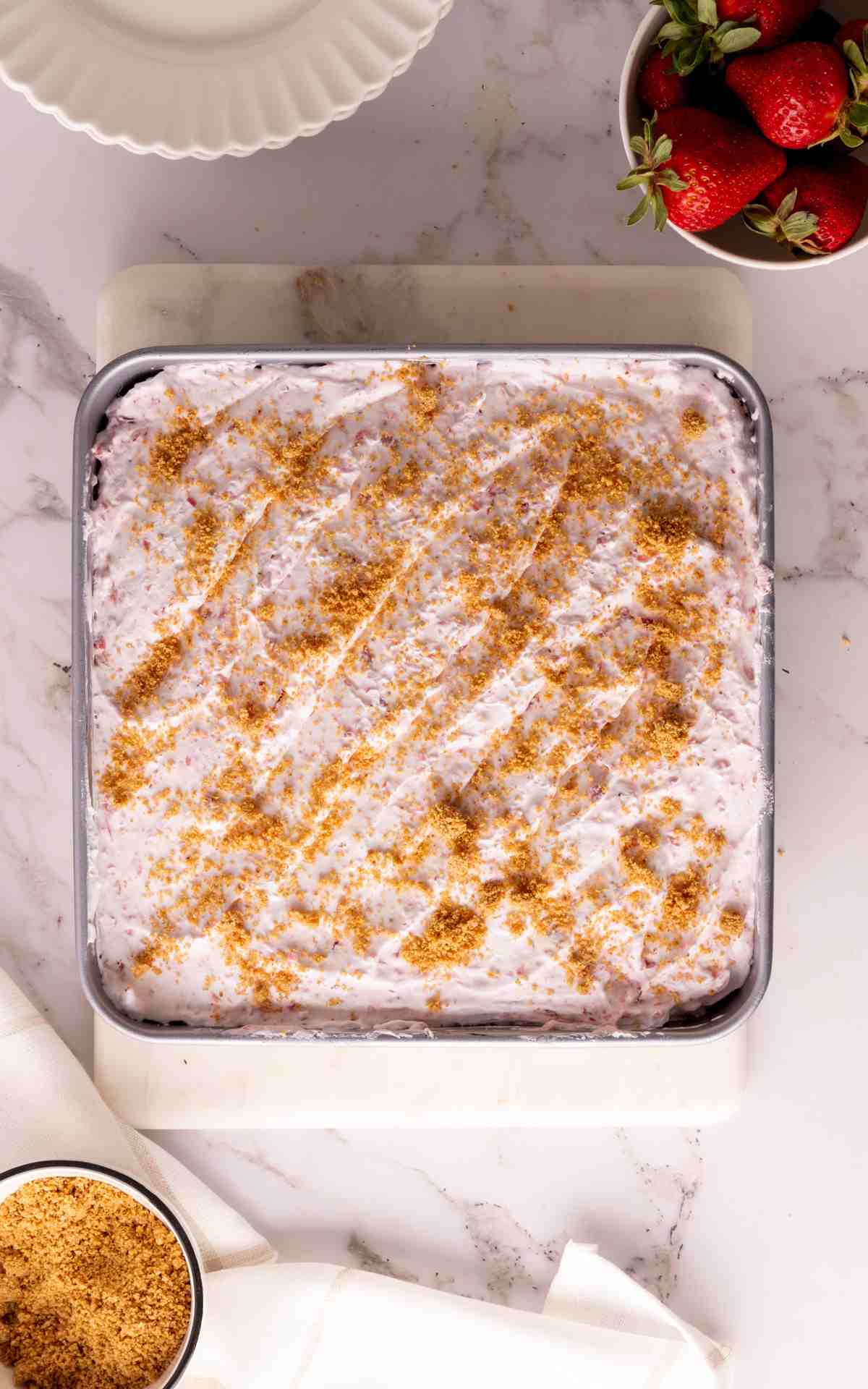 Uncut no bake strawberry dessert with graham cracker crust.