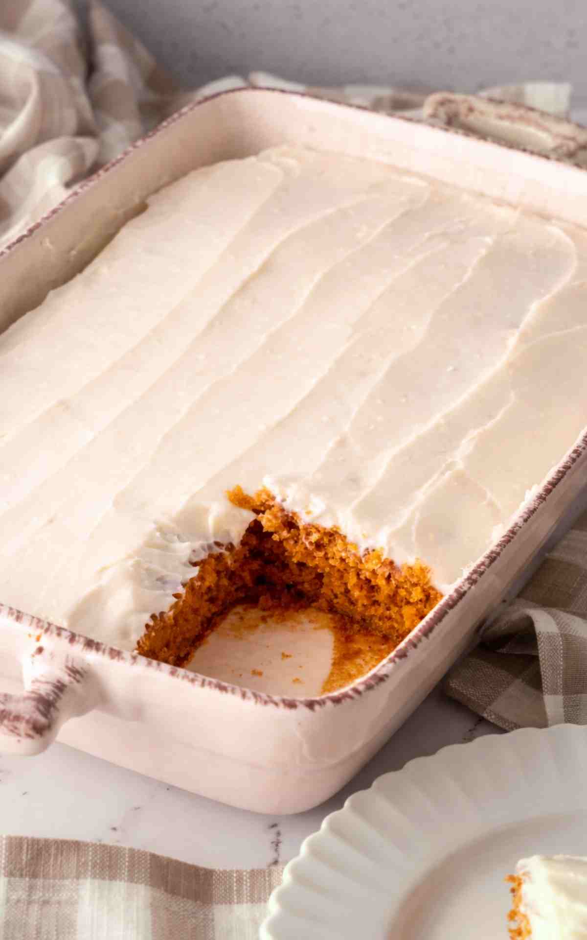 Side angle of a tomato soup cake in a ceramic baking dish.