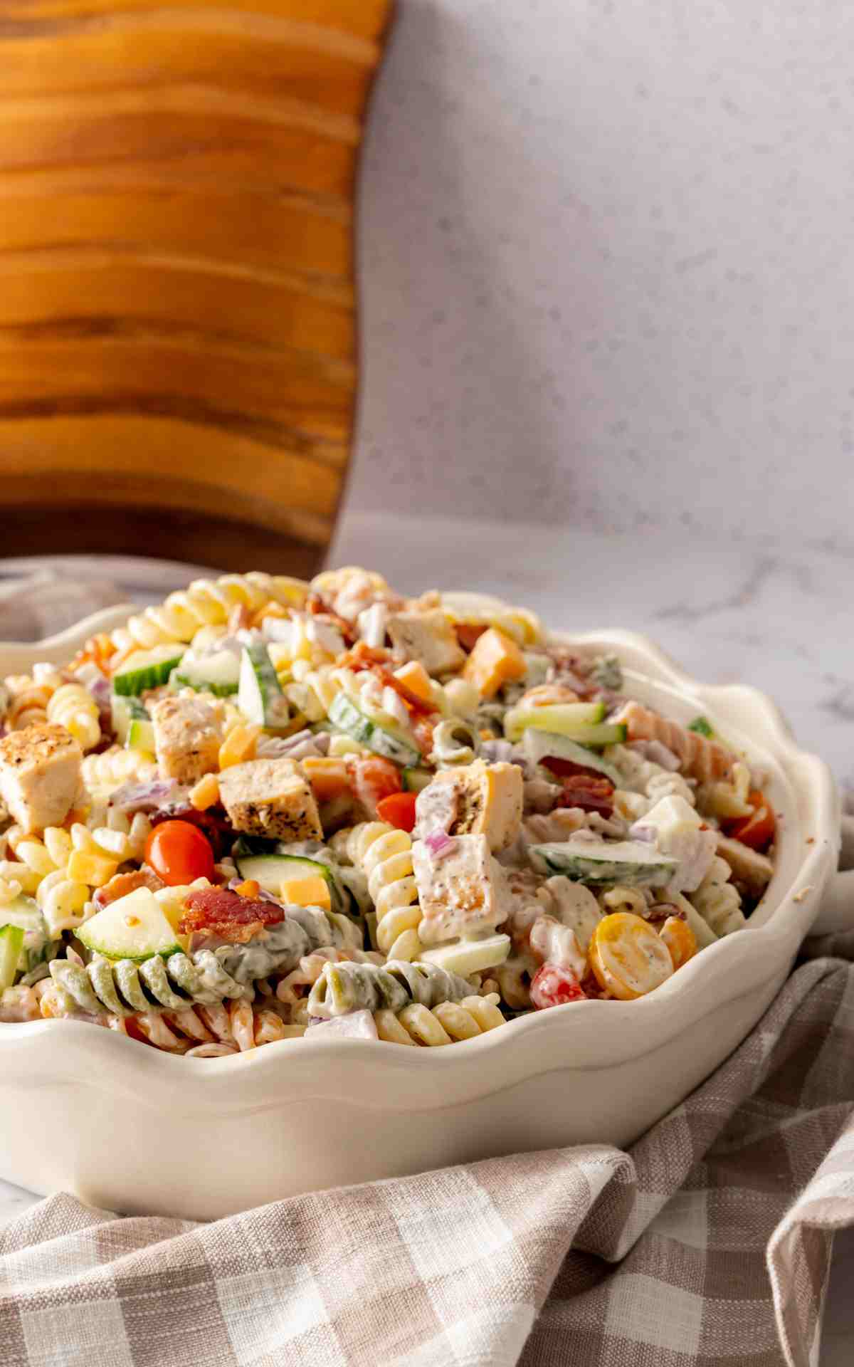 A creamy pasta salad with pasta chicken and veggies.