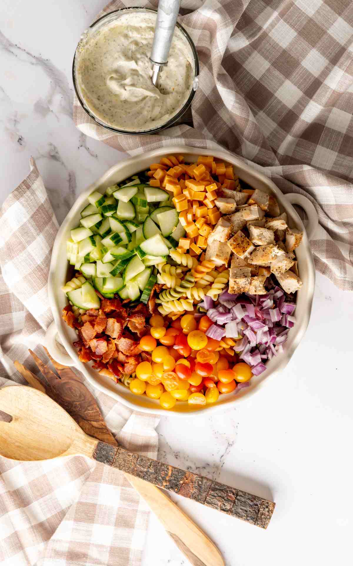 Ingredients for a chicken bacon ranch pasta salad before being mixe.d together