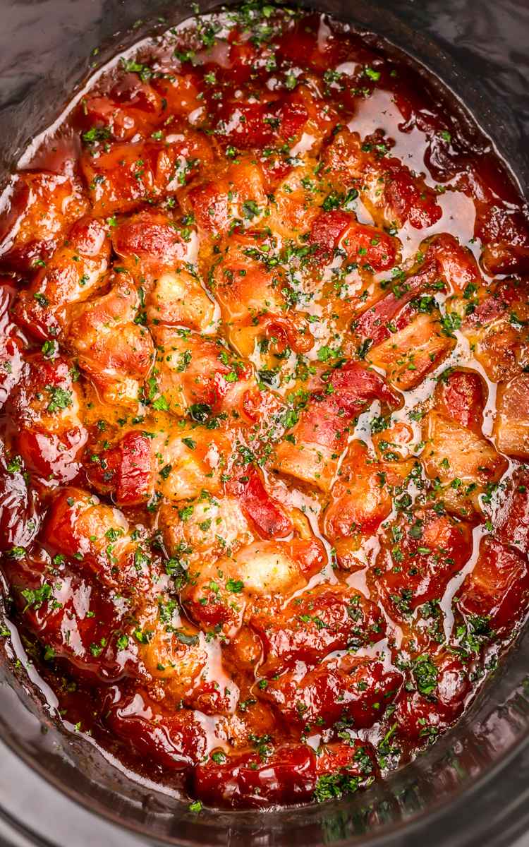 Bacon Wrapped Smokies in BBQ in slow cooker.