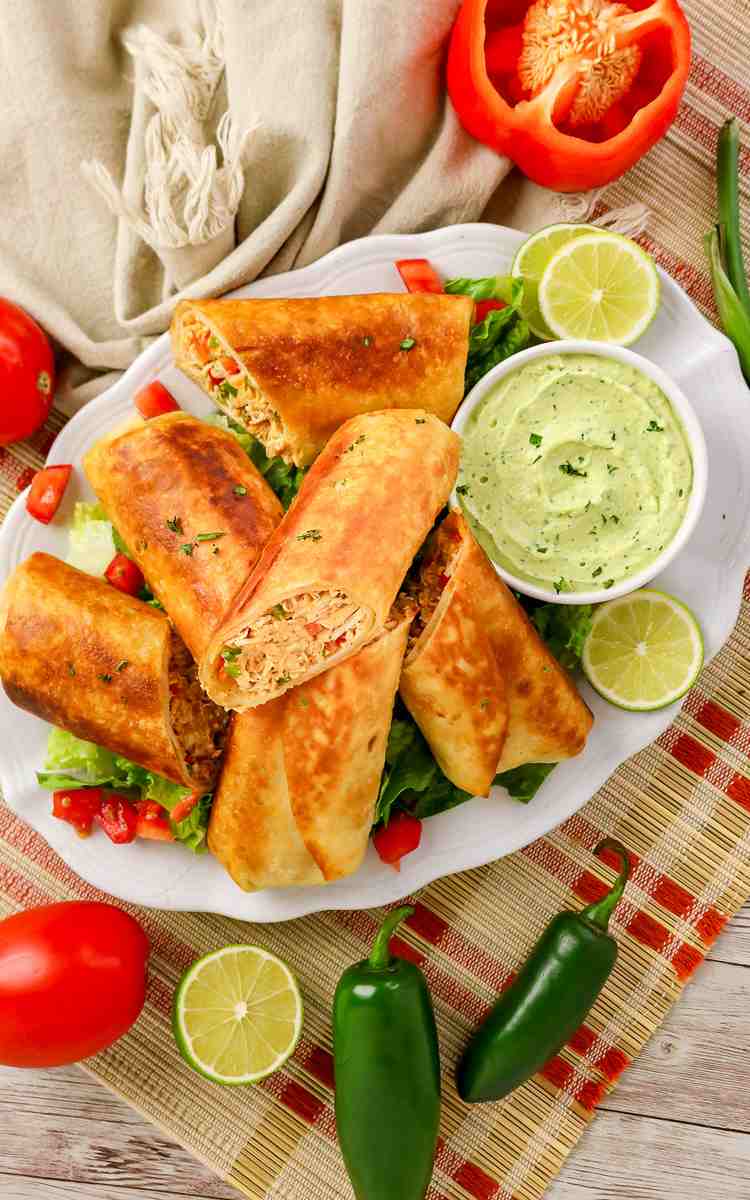 Firecracker chicken wraps cut in half and placed on serving plate.