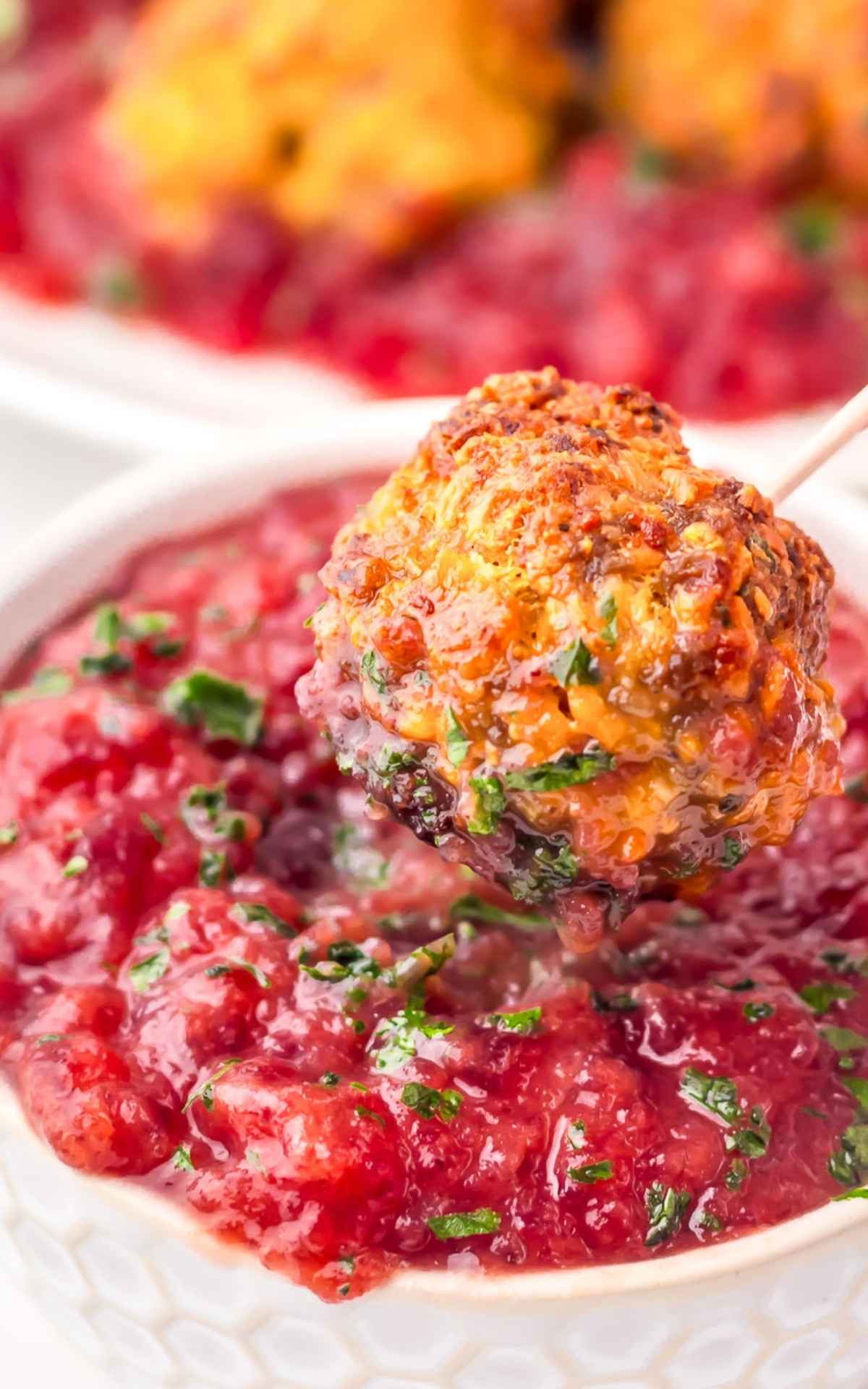 Sausage stuffing balls dipped in cranberry sauce.